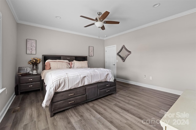 bedroom with crown molding, ceiling fan, and wood-type flooring