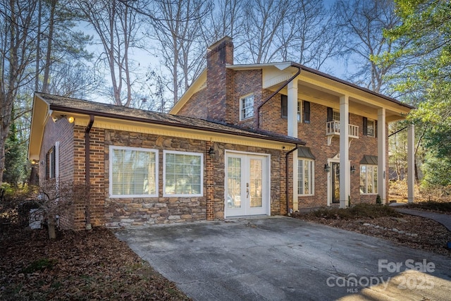 view of front facade featuring french doors and a balcony