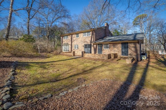 back of house with a lawn