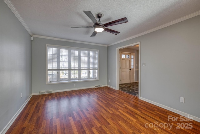 empty room with crown molding, ceiling fan, dark hardwood / wood-style flooring, and a textured ceiling