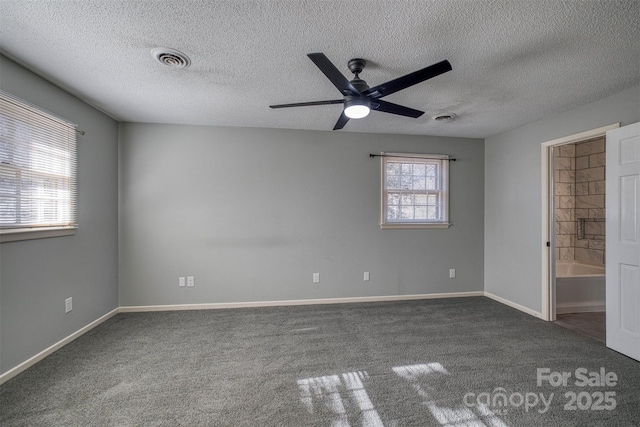 unfurnished bedroom with dark colored carpet, a textured ceiling, and ceiling fan