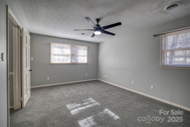 unfurnished bedroom with ceiling fan, carpet, and a textured ceiling