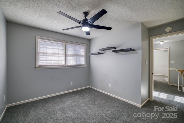 carpeted empty room with ceiling fan and a textured ceiling