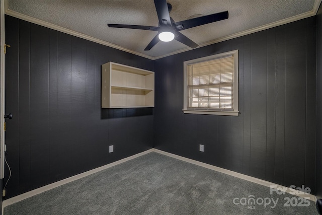 empty room with crown molding, a textured ceiling, and carpet