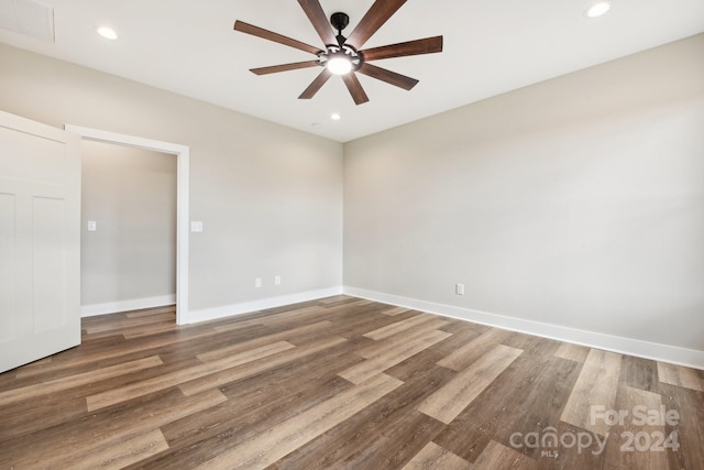 empty room with hardwood / wood-style floors and ceiling fan