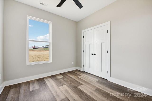 unfurnished bedroom featuring ceiling fan, a closet, and light hardwood / wood-style floors