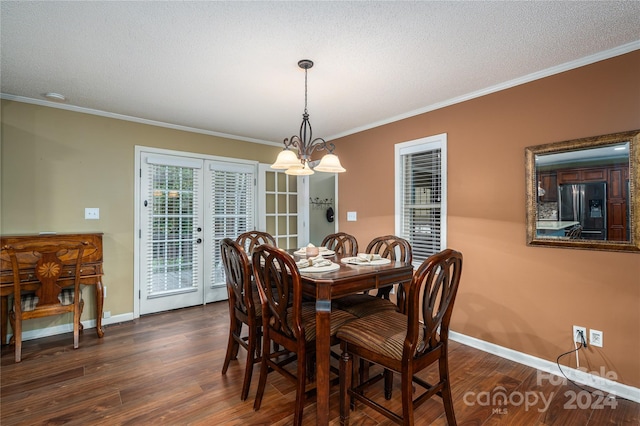 dining room with ornamental molding, a chandelier, a textured ceiling, and dark wood-type flooring