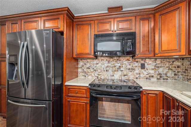 kitchen featuring a textured ceiling, light stone countertops, backsplash, and black appliances