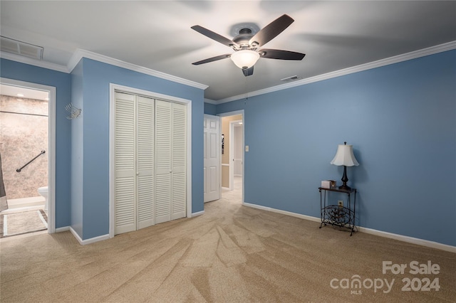 unfurnished bedroom with a closet, light carpet, connected bathroom, ornamental molding, and ceiling fan