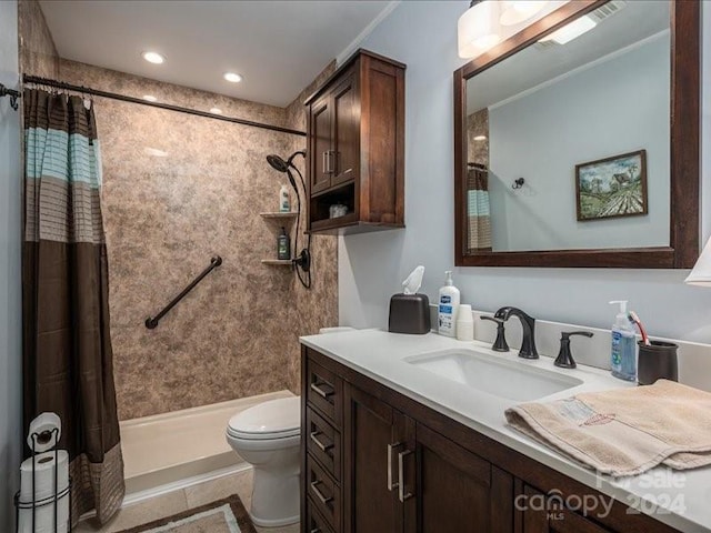 bathroom with a shower with curtain, vanity, tile patterned flooring, and toilet