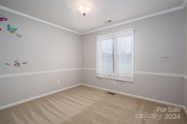 carpeted spare room featuring a textured ceiling and ornamental molding