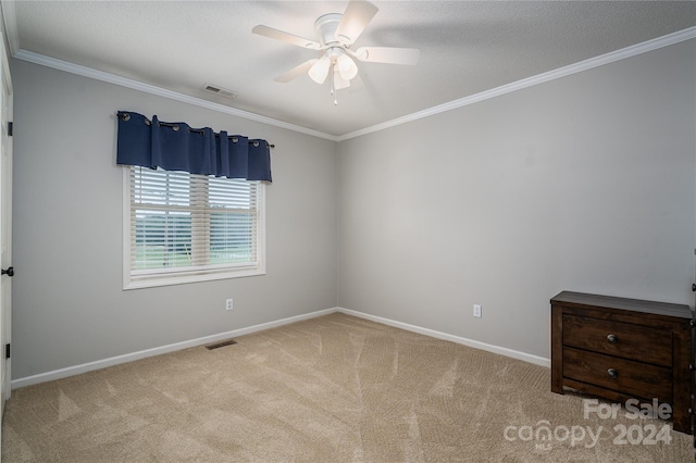 spare room featuring ornamental molding, ceiling fan, and light colored carpet