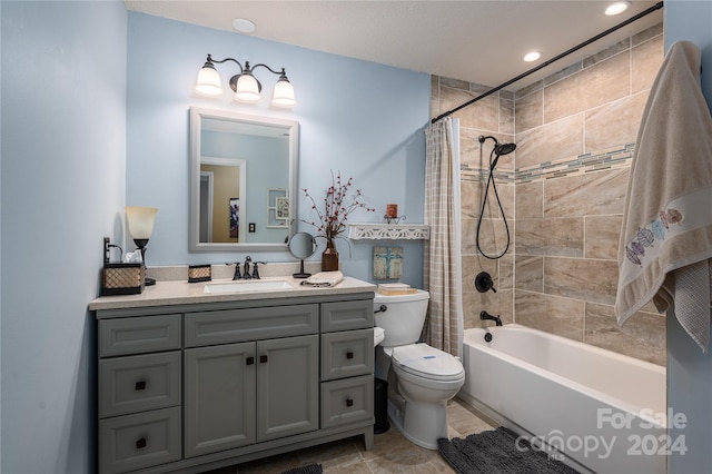 full bathroom with shower / tub combo with curtain, vanity, and toilet