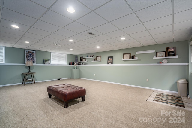 rec room featuring a paneled ceiling and carpet flooring