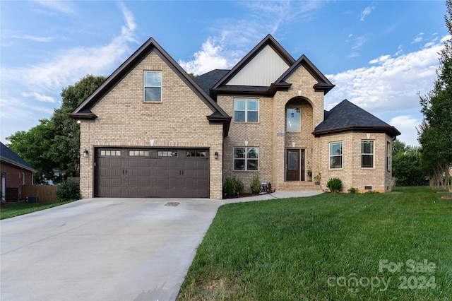 view of front of home featuring a front lawn and a garage