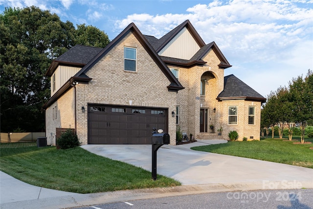 view of front of property featuring central AC unit, a front lawn, and a garage