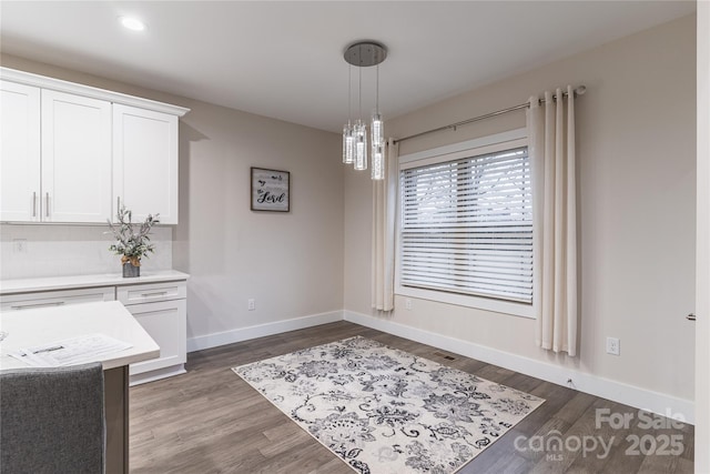 unfurnished dining area with dark wood-type flooring and a notable chandelier