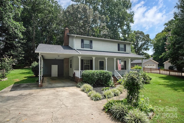 view of front of home with a front lawn, a carport, and a porch