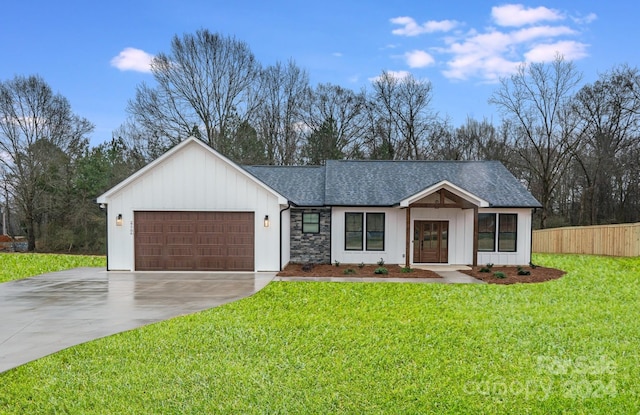 view of front of property with a garage and a front yard