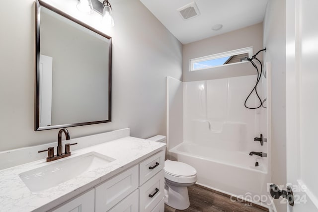 full bathroom with vanity, hardwood / wood-style flooring, bathing tub / shower combination, and toilet