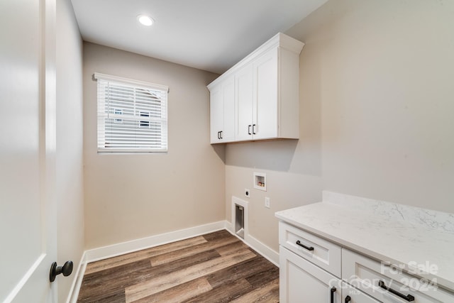 washroom featuring cabinets, electric dryer hookup, dark wood-type flooring, and washer hookup