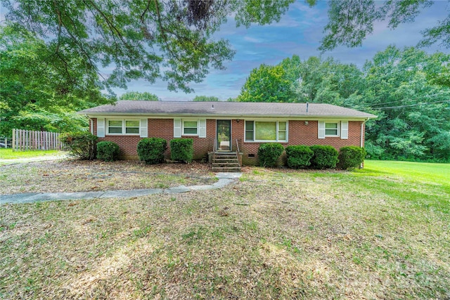 single story home featuring a front lawn