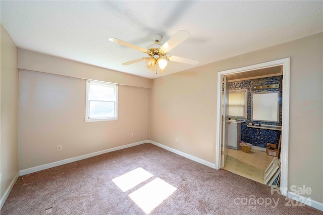 unfurnished bedroom with light colored carpet and ceiling fan