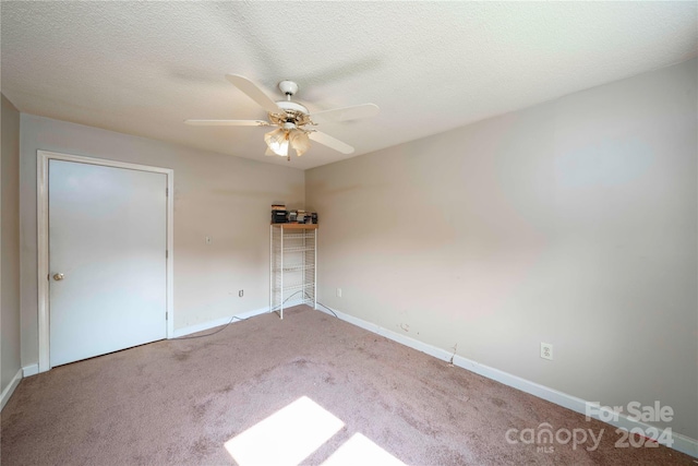 unfurnished bedroom featuring ceiling fan, a textured ceiling, and carpet floors