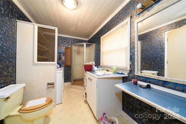 bathroom with washer / dryer, lofted ceiling, toilet, a shower with shower door, and crown molding