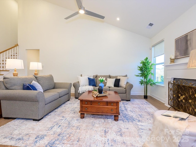 living room featuring lofted ceiling, hardwood / wood-style floors, and ceiling fan