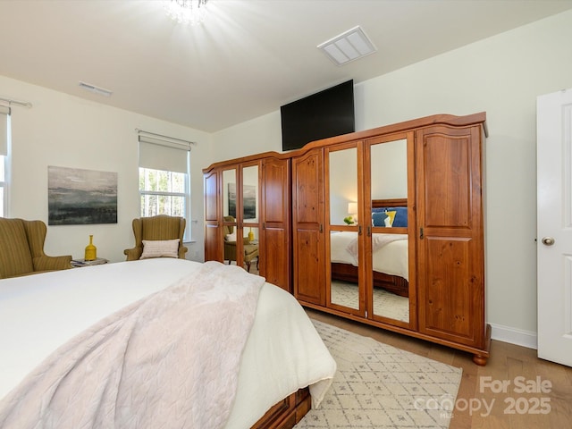 bedroom with light hardwood / wood-style floors