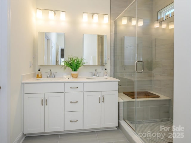 bathroom with tile patterned flooring, vanity, and a shower with shower door