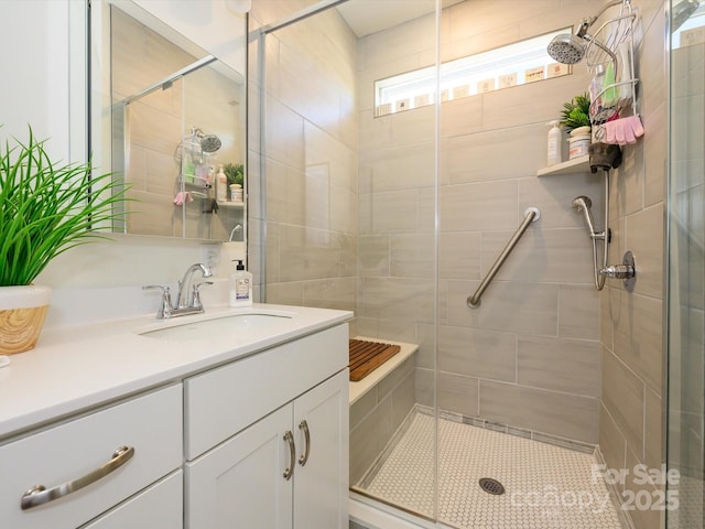 bathroom with vanity and a shower with door