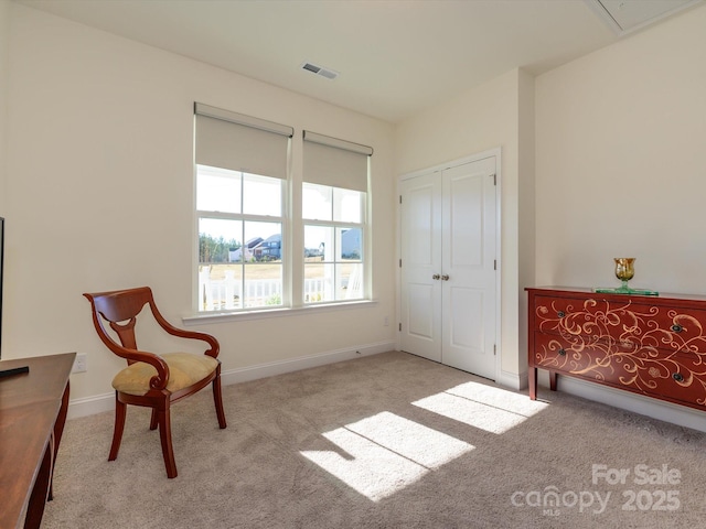 sitting room featuring light colored carpet