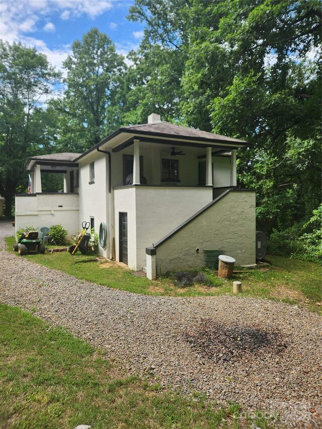 view of side of home with ceiling fan