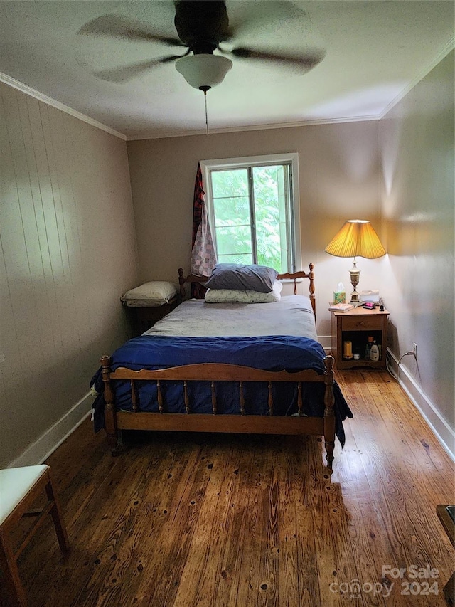 bedroom with ceiling fan, ornamental molding, and wood-type flooring