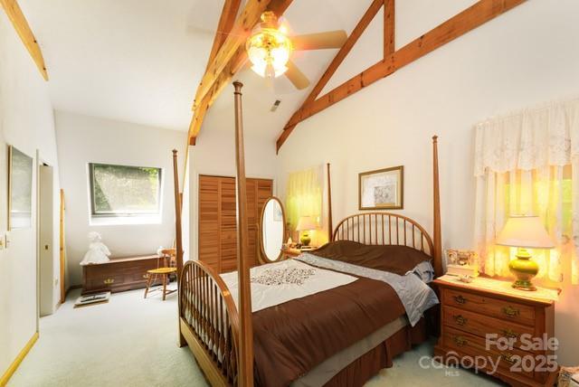 bedroom featuring carpet, high vaulted ceiling, ceiling fan, and beamed ceiling