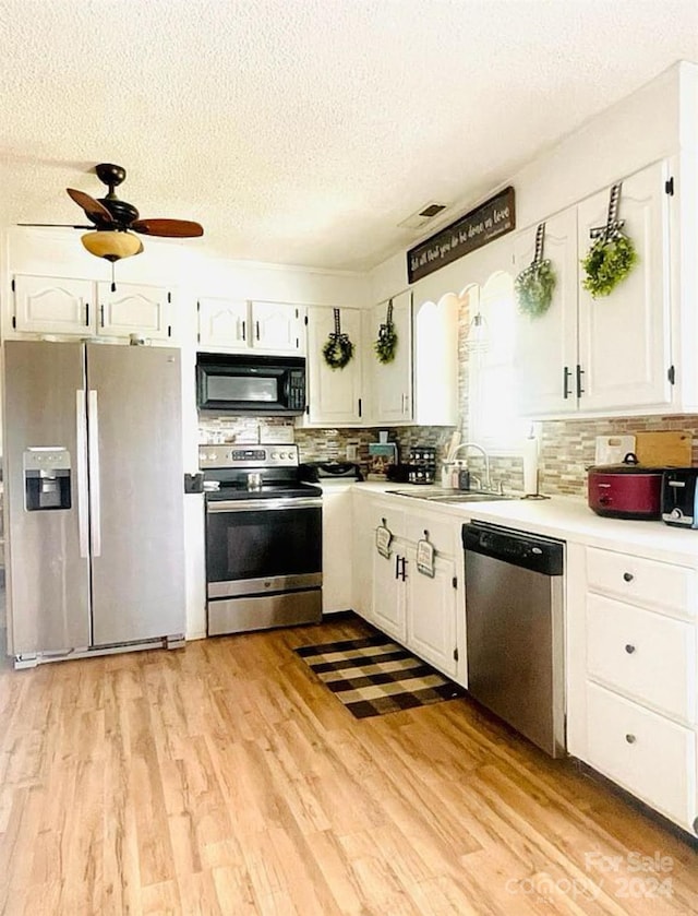 kitchen featuring light hardwood / wood-style flooring, sink, stainless steel appliances, and white cabinetry