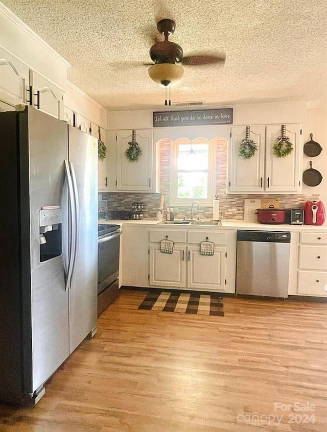 kitchen featuring sink, white cabinetry, and stainless steel appliances