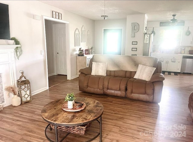 living room with plenty of natural light, a textured ceiling, and hardwood / wood-style flooring