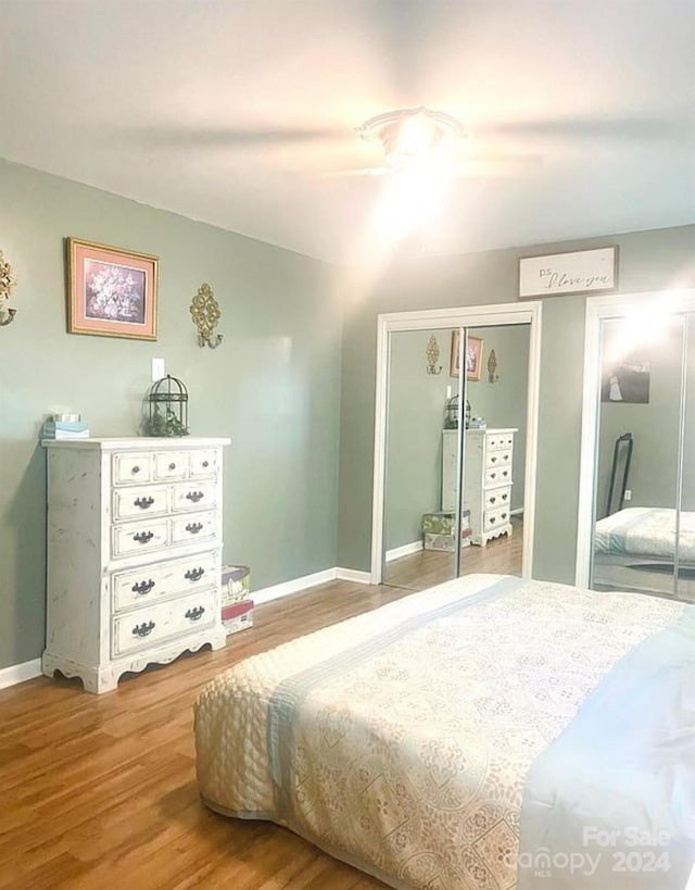 bedroom with ceiling fan and light wood-type flooring