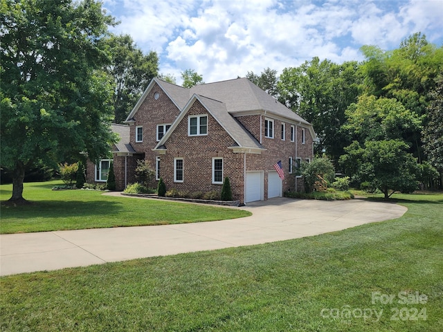 view of front of home featuring a garage and a front lawn