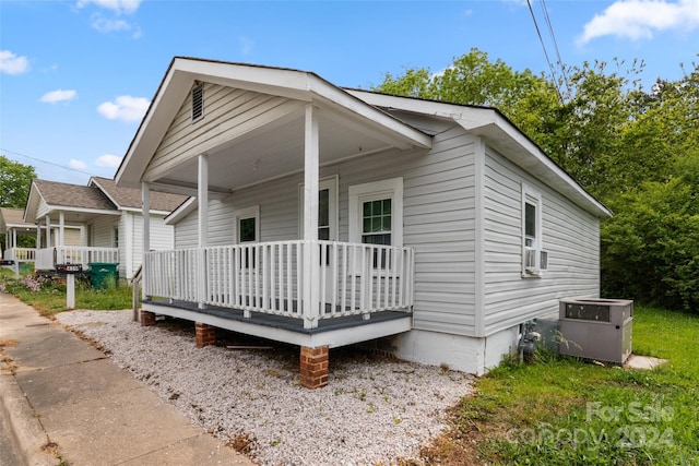 view of front of house with covered porch and cooling unit