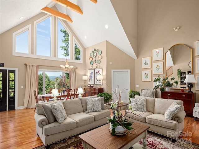 living room featuring a notable chandelier, wood-type flooring, beam ceiling, and high vaulted ceiling