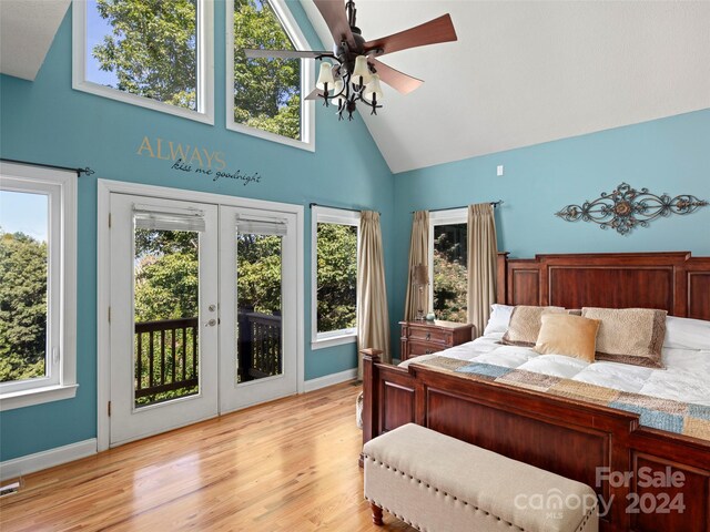 bedroom with access to exterior, multiple windows, and light hardwood / wood-style floors