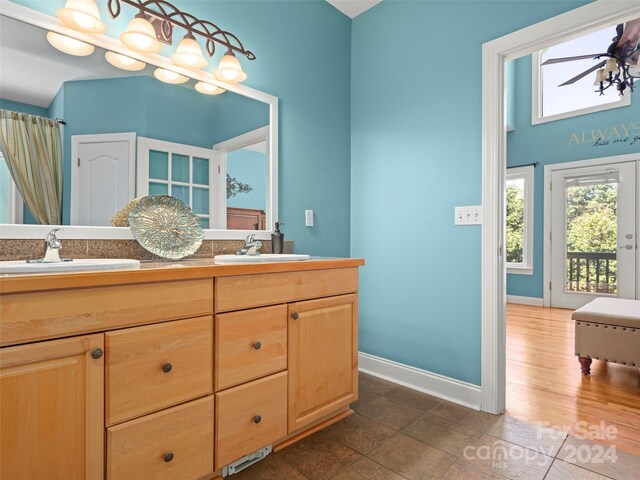 bathroom with tile patterned floors and double vanity