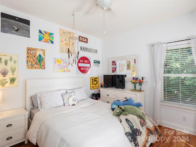 bedroom with hardwood / wood-style floors and ceiling fan