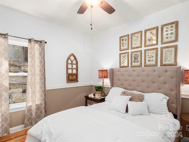 bedroom with hardwood / wood-style flooring and ceiling fan