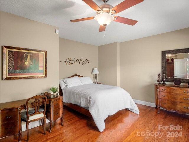 bedroom with hardwood / wood-style flooring and ceiling fan