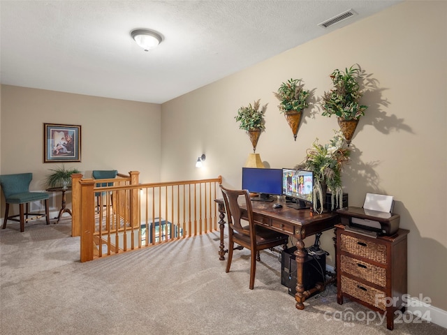 office space featuring carpet floors and a textured ceiling